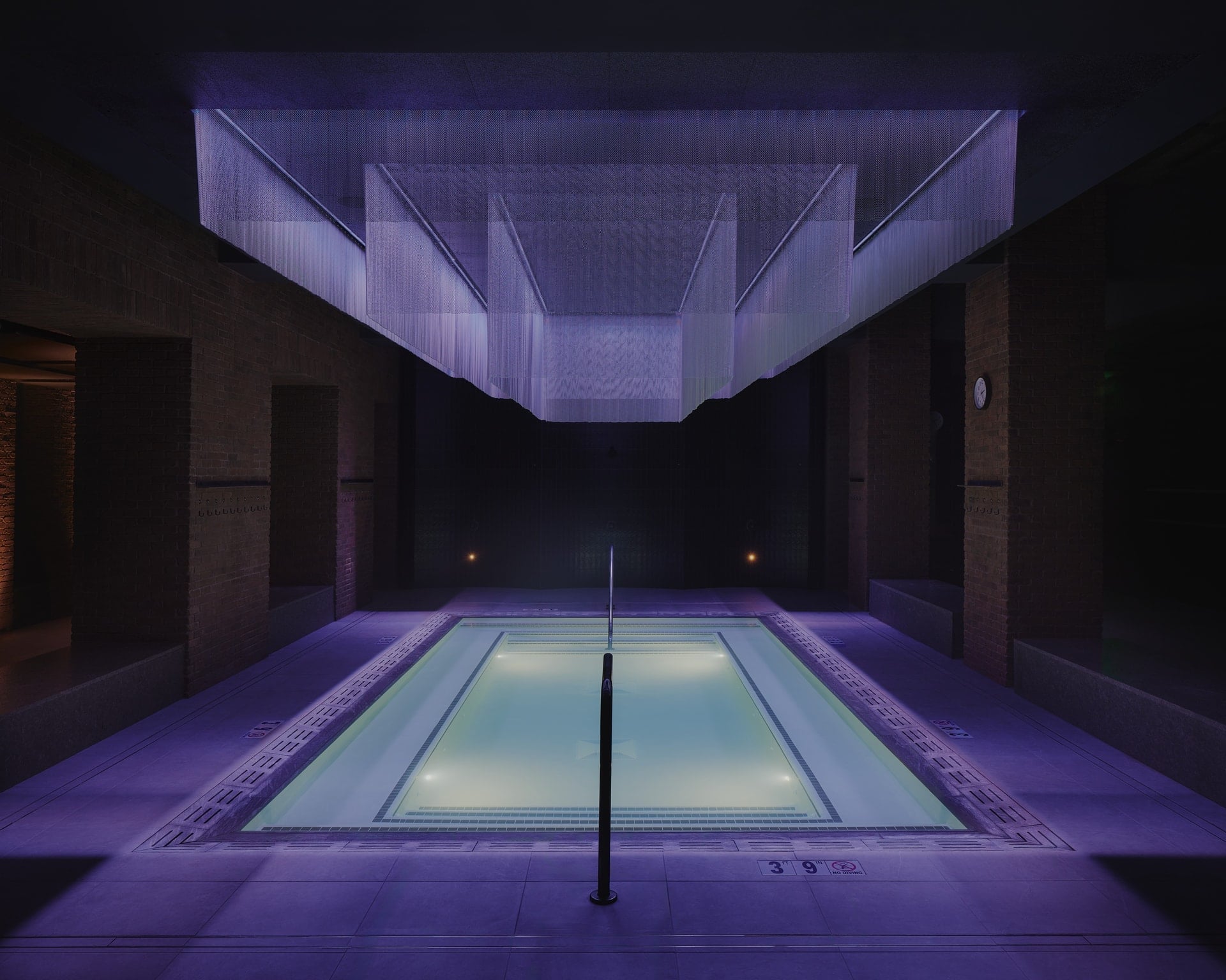 An indoor pool surrounded by lights